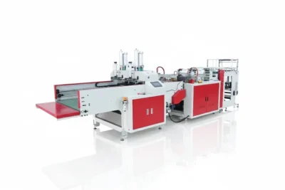 Industrial packaging machine with red and white components, featuring an automated conveyor system.
