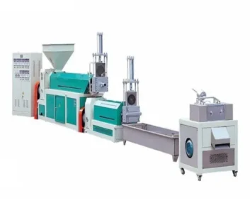 Industrial extrusion machine with multiple components and conveyor system.